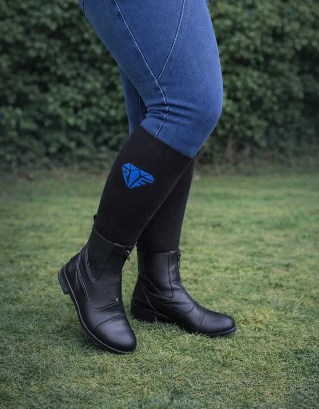 Freedom wide calf riding socks in black and royal, worn under paddock boots, stretch fit for comfort