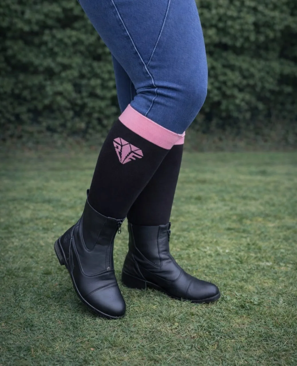 Freedom wide calf riding socks in black and pink, worn under paddock boots, stretch fit for comfort