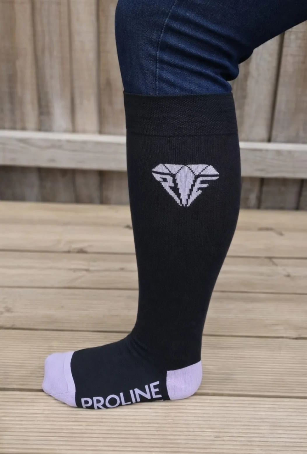 Freedom wide calf riding socks in black and lilac, showing stretch fit and logo detail on the lower leg